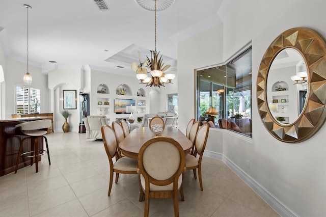 tiled dining room with a wealth of natural light, built in features, and an inviting chandelier