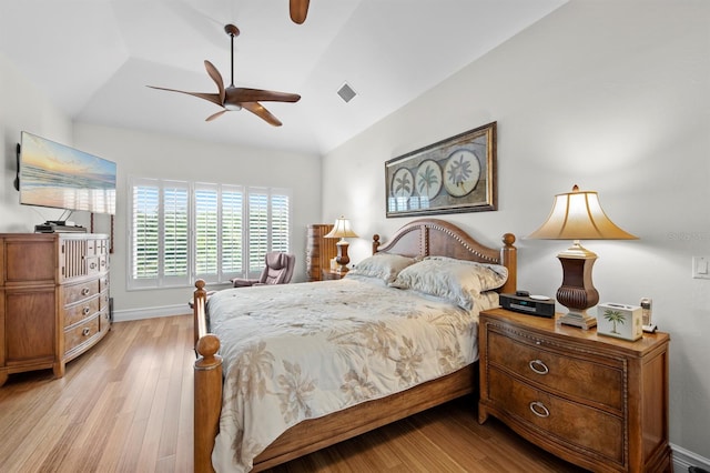 bedroom with vaulted ceiling, ceiling fan, and light hardwood / wood-style flooring