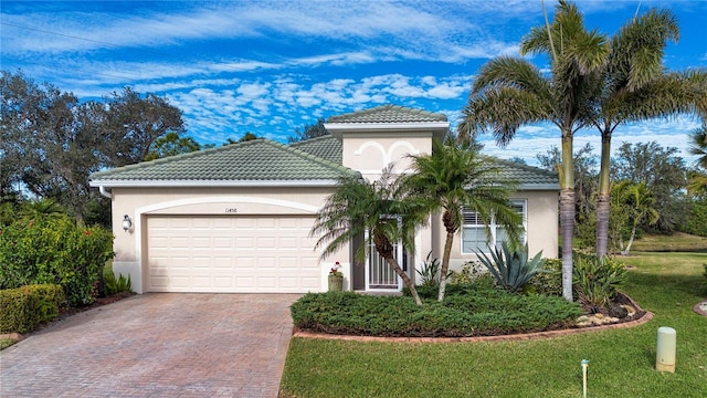 mediterranean / spanish-style home with a garage and a front yard