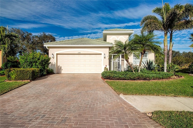 mediterranean / spanish house with a garage