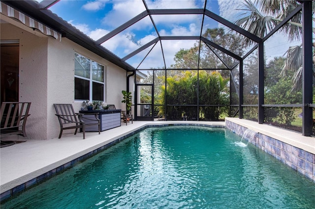 view of swimming pool with pool water feature, glass enclosure, and a patio area