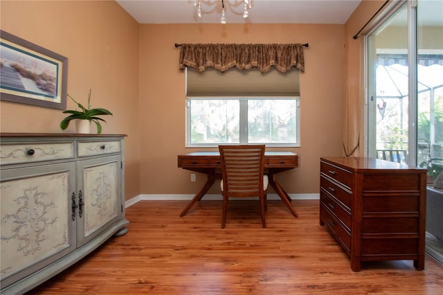 living area with a healthy amount of sunlight and light hardwood / wood-style flooring