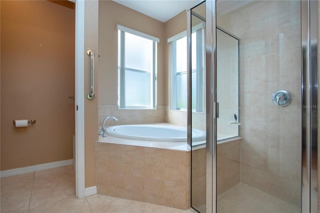 bathroom featuring tile patterned floors and separate shower and tub