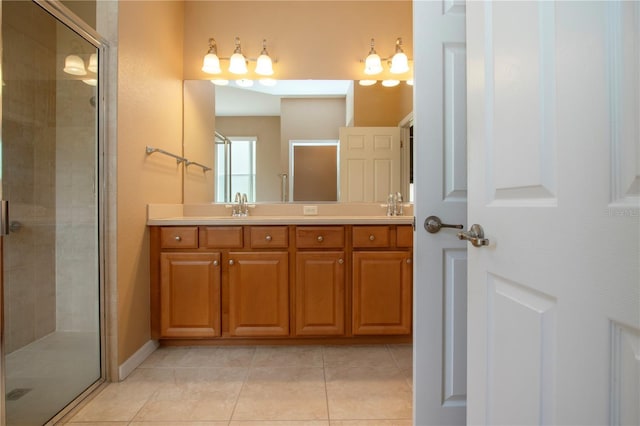 bathroom featuring tile patterned flooring, vanity, and a shower with shower door