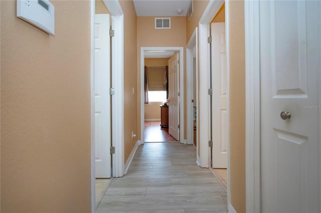 corridor with light wood-type flooring