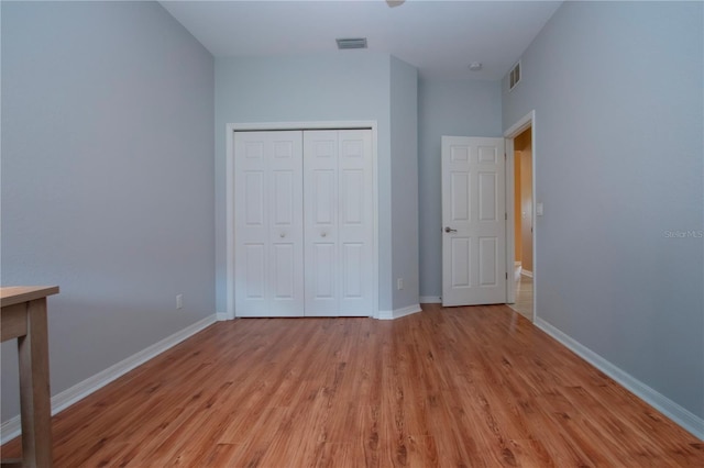 unfurnished bedroom featuring light hardwood / wood-style floors and a closet