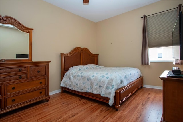 bedroom with ceiling fan and light hardwood / wood-style flooring