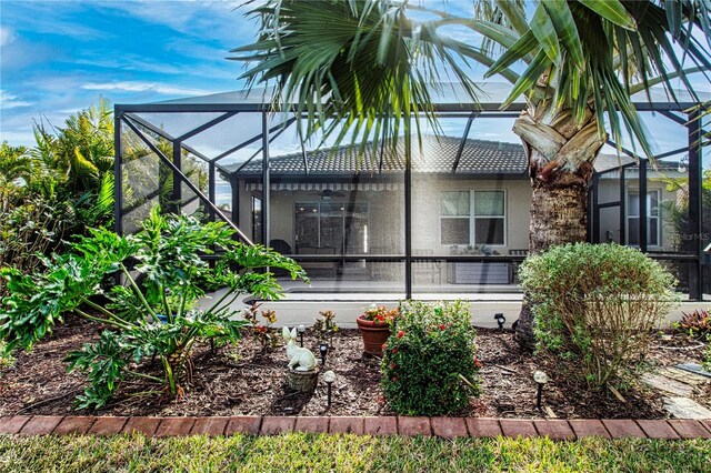 view of property exterior featuring glass enclosure