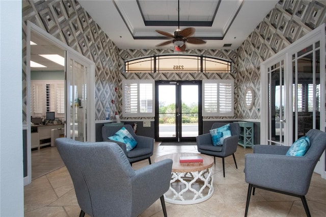 living room with french doors, ceiling fan, crown molding, and a raised ceiling