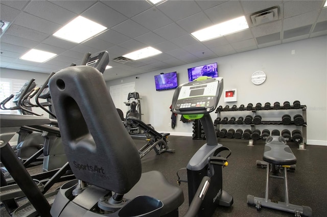 exercise room with a paneled ceiling