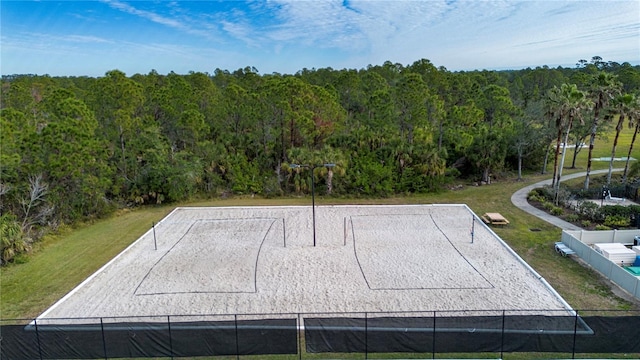 view of property's community featuring a lawn and volleyball court