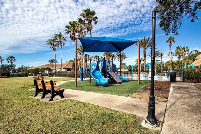 view of jungle gym featuring a lawn