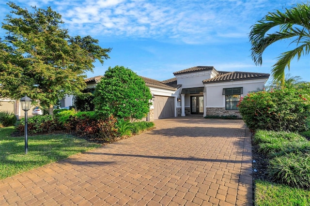 mediterranean / spanish house with a garage