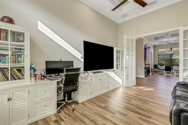 office space featuring crown molding, light hardwood / wood-style floors, french doors, and ceiling fan