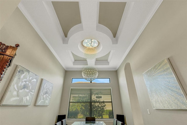 room details featuring an inviting chandelier, ornamental molding, and coffered ceiling