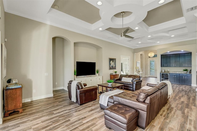 living room with coffered ceiling, ornamental molding, beverage cooler, and light wood-type flooring