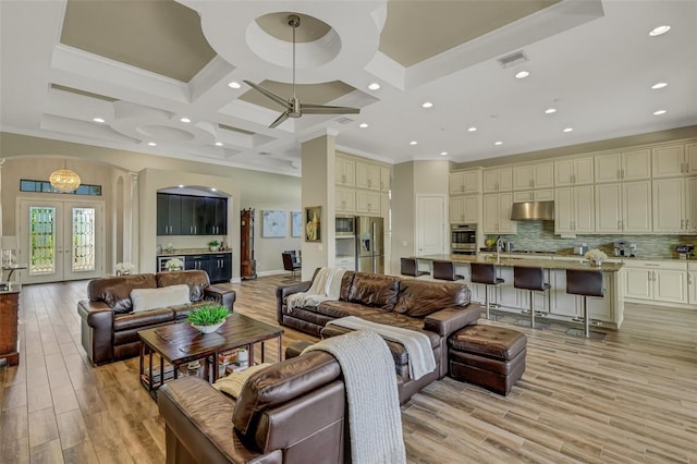 living room featuring french doors, coffered ceiling, light hardwood / wood-style flooring, ornamental molding, and beam ceiling