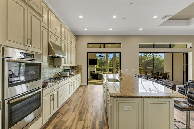 kitchen featuring cream cabinets, stainless steel appliances, and sink