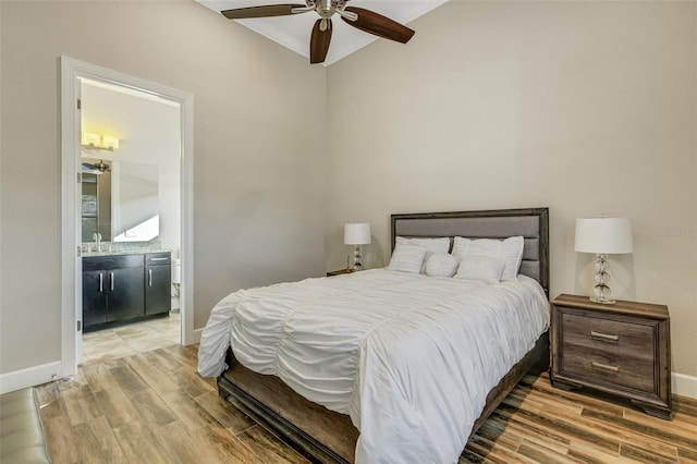 bedroom with connected bathroom, sink, ornamental molding, hardwood / wood-style flooring, and ceiling fan