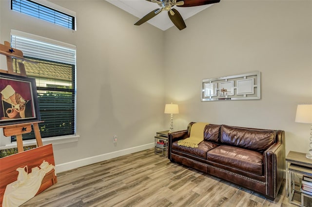 living room with ceiling fan and light wood-type flooring