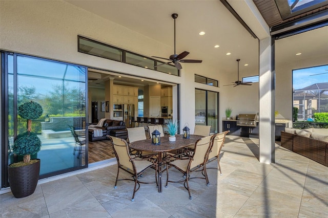 view of patio / terrace featuring area for grilling, a grill, and ceiling fan