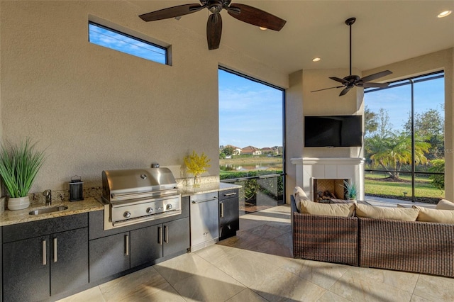 view of patio / terrace featuring an outdoor living space with a fireplace, grilling area, sink, and area for grilling