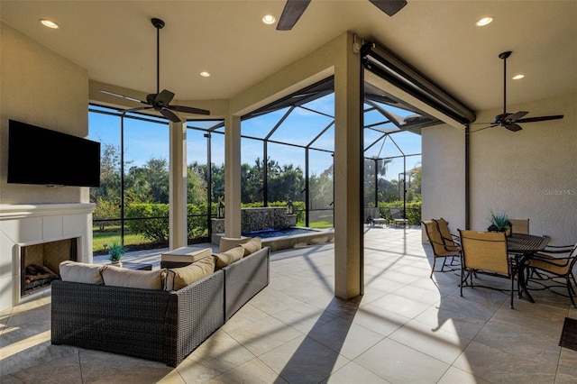 view of patio with ceiling fan and an outdoor living space with a fireplace