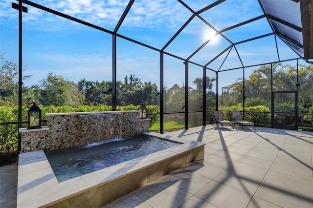 view of patio featuring a hot tub, pool water feature, and glass enclosure