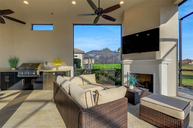 view of patio with a tiled fireplace, area for grilling, and ceiling fan