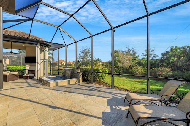 view of patio / terrace featuring a lanai and exterior fireplace