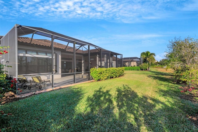 view of yard featuring a patio and glass enclosure