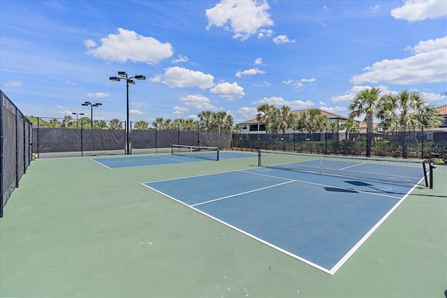 view of tennis court featuring basketball hoop