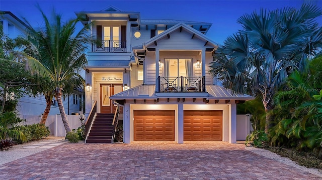 view of front of property featuring a garage and a balcony