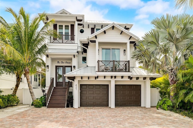 view of front of home featuring a balcony and a garage