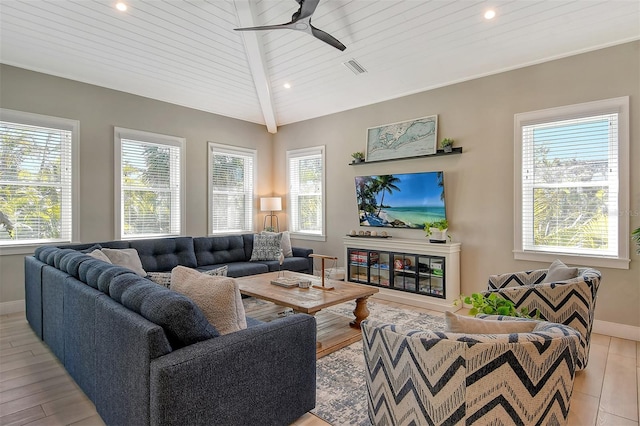 living room featuring wood ceiling, ceiling fan, a healthy amount of sunlight, and vaulted ceiling with beams