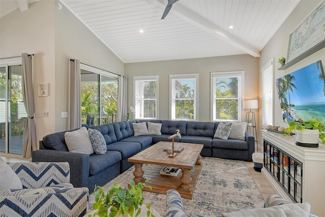 living room featuring lofted ceiling with beams and a healthy amount of sunlight