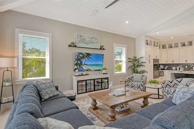 living room with vaulted ceiling, plenty of natural light, and wooden ceiling