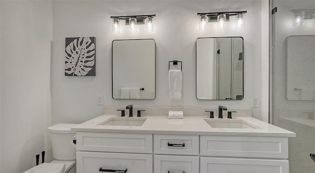 bathroom featuring vanity, toilet, and walk in shower