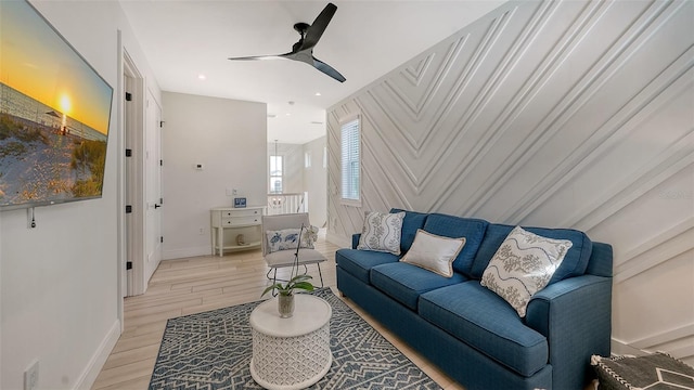 living room featuring ceiling fan and light hardwood / wood-style floors