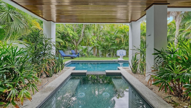 view of pool featuring an in ground hot tub