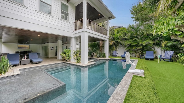 view of pool with a patio and a yard