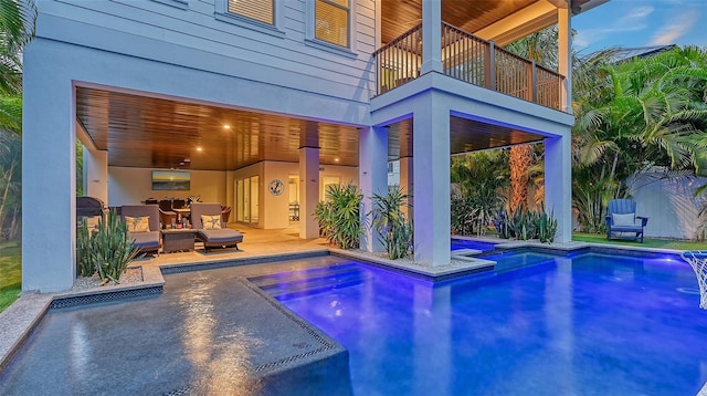 view of pool featuring a hot tub and a patio area