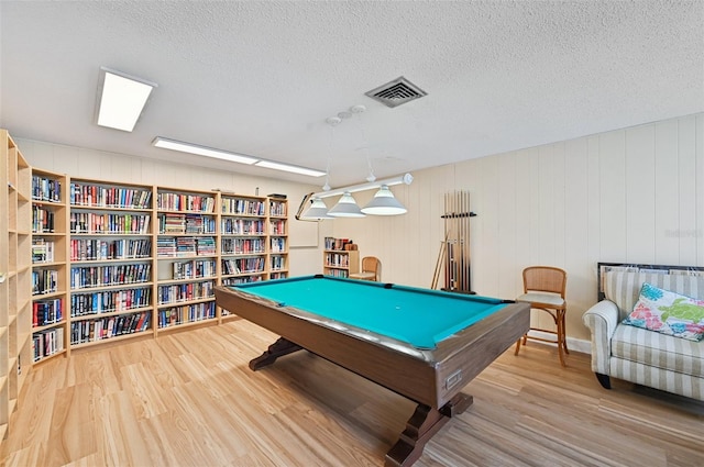 rec room featuring hardwood / wood-style floors, billiards, and a textured ceiling