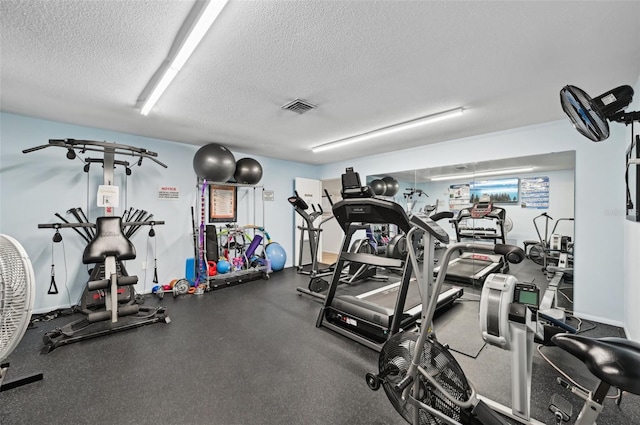 workout area featuring a textured ceiling