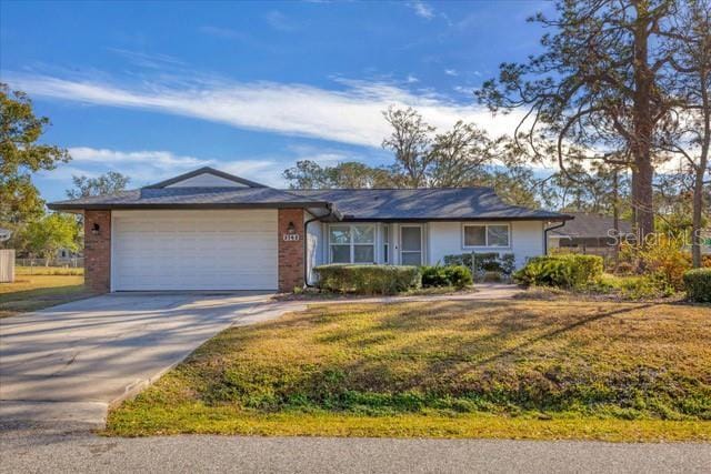 ranch-style home featuring a garage and a front lawn