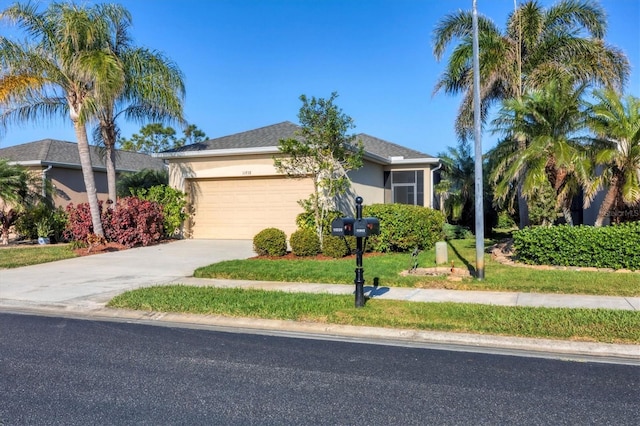 view of front of property featuring a garage and a front yard