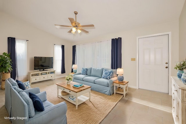 tiled living room with ceiling fan and vaulted ceiling