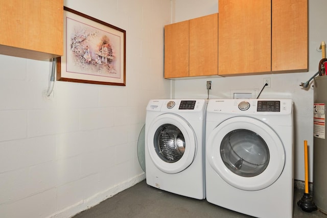 clothes washing area featuring cabinets and independent washer and dryer