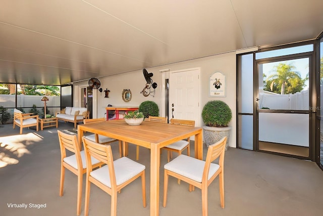 dining room with a healthy amount of sunlight and concrete flooring