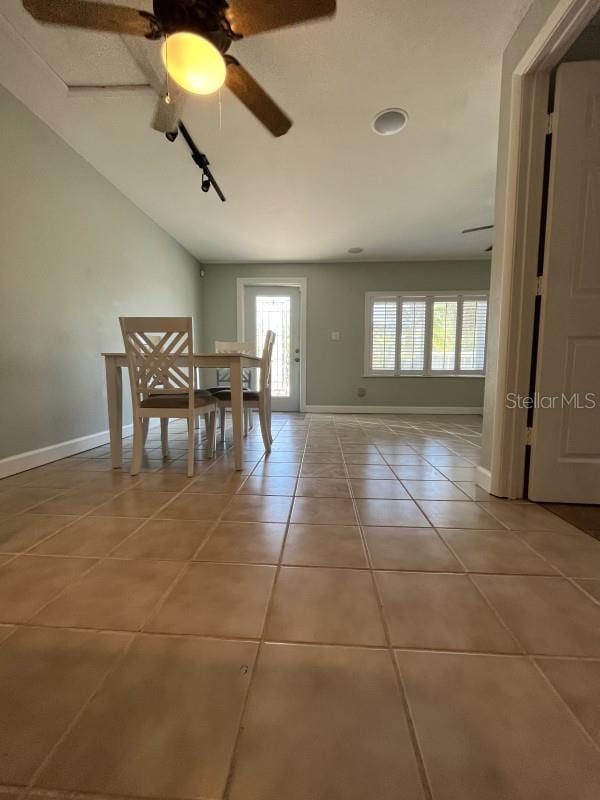 unfurnished dining area with ceiling fan, tile patterned floors, and a healthy amount of sunlight